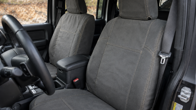 Heavy-duty canvas fabric seat covers installed on Jeep Wrangler front seats showing rugged texture and tight custom fit