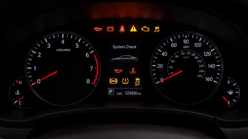 A modern car instrument cluster dashboard showing multiple warning lights illuminated in red, yellow, and orange colors representing different system alerts