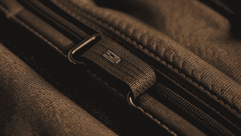 Close-up shot of reinforced D-rings and 600D Oxford polyester stitching on a high-end automotive organizer.