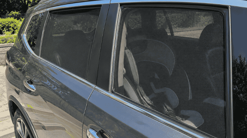 Mesh car side window sun shades installed on rear passenger windows providing UV protection while still allowing visibility through the window