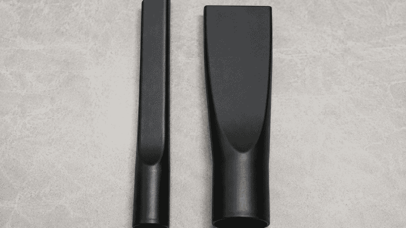Two crevice tool attachments side by side showing the difference between a slim narrow tool that fits car seat gaps and a wide tool that cannot reach into tight spaces