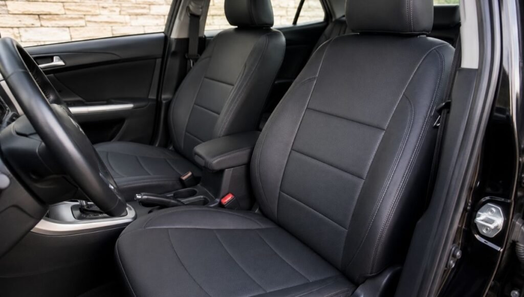 A leatherette faux leather car seat cover installed on a front seat showing the premium appearance and smooth surface that mimics genuine leather