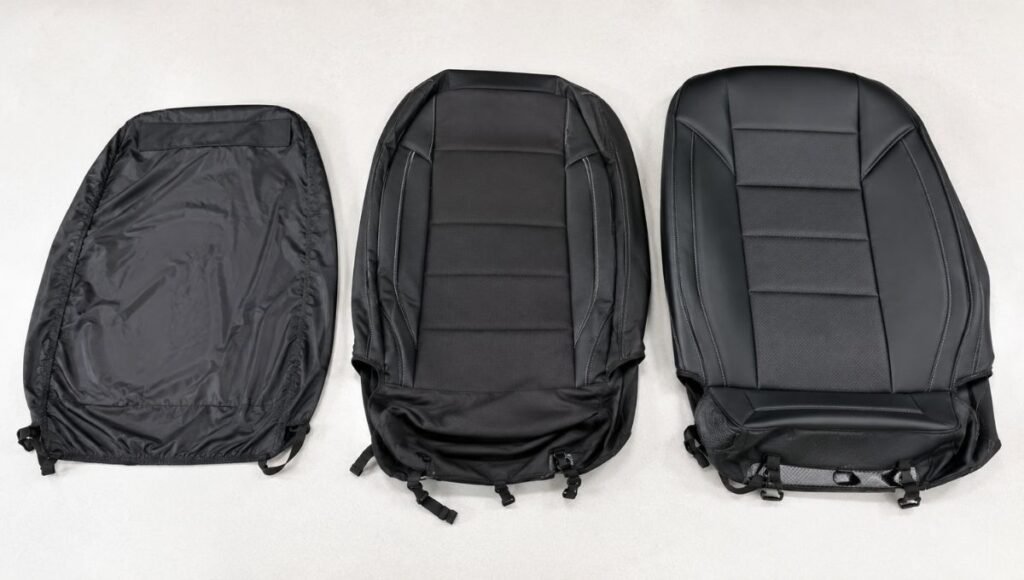 Three different quality car seat covers laid out side by side showing the material and construction quality differences between budget universal and premium custom-fit options