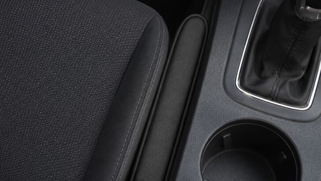 A seat gap filler foam insert installed in the gap between a car seat and center console preventing items from falling into the space